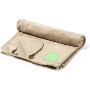 A rolled beige blanket with a textured edge and a square patch is displayed, featuring a logo.