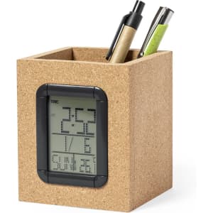 A cork pencil holder with a digital clock display, containing pens in black, green, and brown.