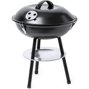 A black barbecue grill with a rounded lid and a stand, featuring a chrome shelf underneath. It has ventilation holes.