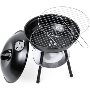 A black barbecue grill with a round body, metal legs, and a silver cooking grate. It features a lid and a handle.