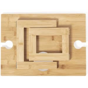 A bamboo table with three nested frames in a natural colour, featuring cut-out handles on the sides.