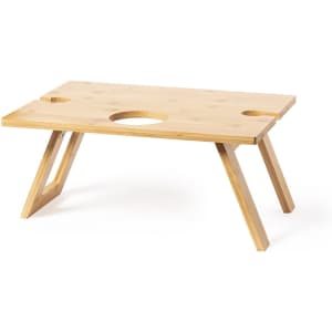 A bamboo table with two circular cutouts, featuring angled legs for stability and a natural wood finish.