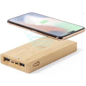 A power bank made of bamboo with multiple USB ports and wireless charging capability, alongside a smartphone.