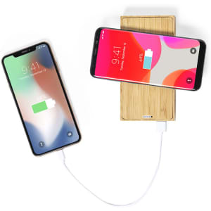 A bamboo power bank with two smartphones connected, showcasing a charging feature. The power bank has a logo.