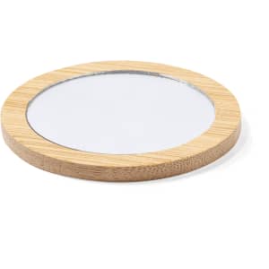A round pocket mirror with a bamboo frame and a reflective surface in the centre.