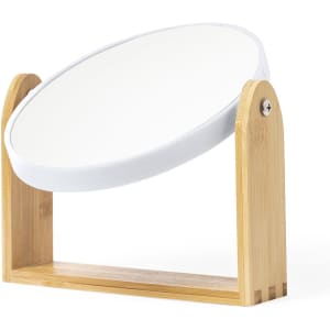 A round mirror with a white surface and a wooden bamboo base, featuring a minimalistic design.
