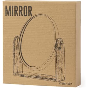 A round mirror in a wooden stand, presented in a brown cardboard box featuring a simple illustration.