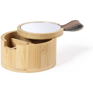 A round bamboo jewellery box with a mirror and a brown leather strap, featuring compartments for organising accessories.