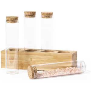 A spice set featuring clear glass test tubes with cork stoppers, presented on a bamboo holder.