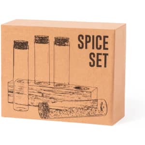 A spice set packaged in a brown box, featuring four glass spice containers with cork lids and a wooden holder.