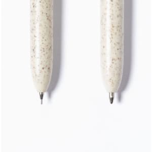 A set of two cream-coloured pens with a speckled design, featuring metal tips and a branding logo.