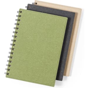 Three spiral-bound notebooks in green, grey, and beige, featuring a textured cover and a logo on the front.