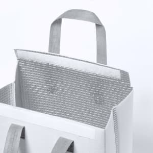 A cooler bag with grey handles and a textured silver interior, featuring a simple, modern design.