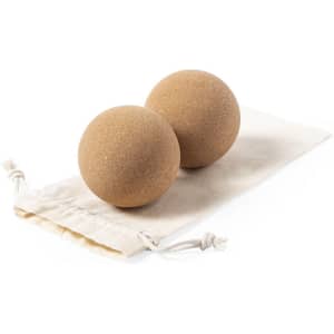 Two tan-coloured balls on a cream drawstring pouch. The set is visually appealing and designed for outdoor leisure activities.