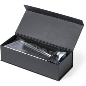 A clear glass trophy displayed inside a black box with a sleek design, featuring a logo on the trophy.