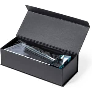 A crystal trophy placed inside a black gift box, featuring a sleek, modern design with a clear finish.