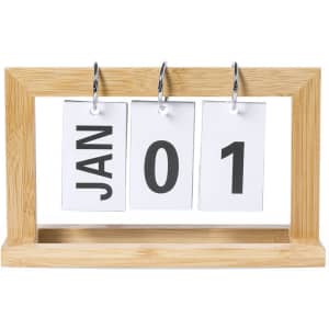 A bamboo desk calendar displaying the month and day with white cards and bold black numbers.