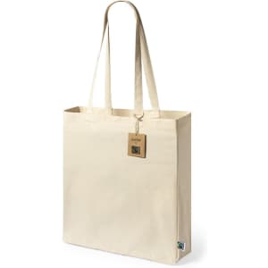 A beige tote bag with long handles and a tag, featuring a logo on the side.
