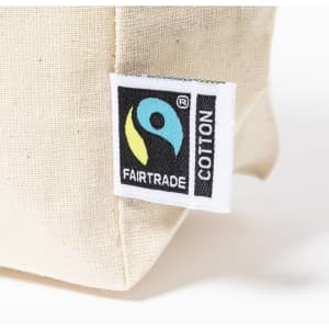 A cream-coloured toiletry bag with a Fairtrade cotton logo tag.