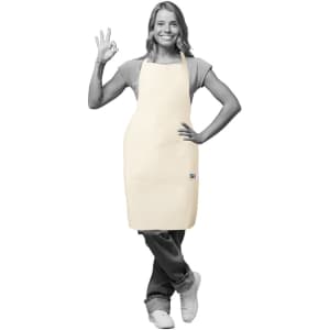 A light-coloured Fairtrade apron worn by a person, featuring a logo and a relaxed pose.