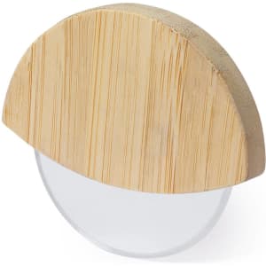 A bamboo pizza cutter with a semicircular wooden handle and a clear cutting blade. It features a branded logo.