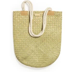 A green woven tote bag with a round shape, featuring natural rope handles and a small brand logo.