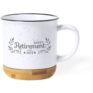 A coffee mug with a speckled white body and a bamboo base, featuring a retirement-themed design.