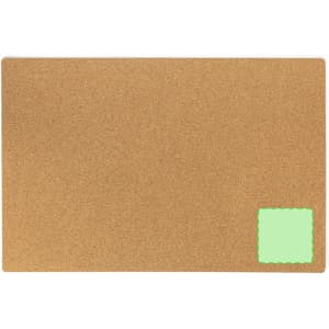A cork mat in tan with a small green square on one corner, featuring a simple, textured surface.