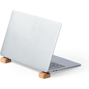 A silver laptop elevated on a wooden stand, showcasing a minimalist design. The stand has a smooth finish.