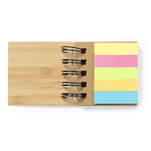 A wooden sticky notepad with yellow, pink, and blue sticky notes attached by a metal binder.