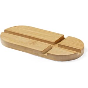 A bamboo phone stand with multiple grooves for holding devices, featuring a smooth, natural finish.