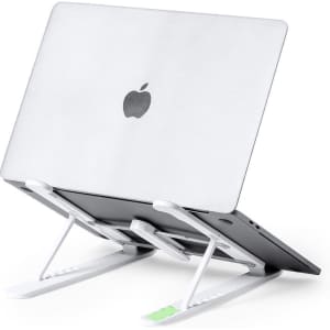 A laptop stand in white, supporting a silver laptop with an Apple logo, designed for ergonomic use.
