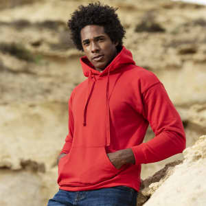 A red adult hooded sweatshirt with a front pocket and a logo, worn by a person outdoors.