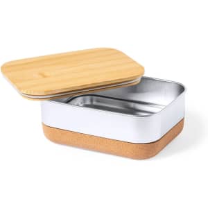 A lunch box with a bamboo lid, a silver metal interior, and a cork base in natural tones.