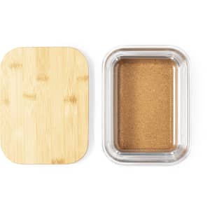 A transparent container with a bamboo lid, featuring a light brown substance inside.