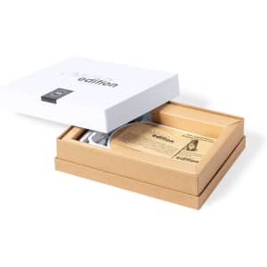 A boxed set featuring a product with a light cardboard exterior and an interior compartment, with a branding logo present.