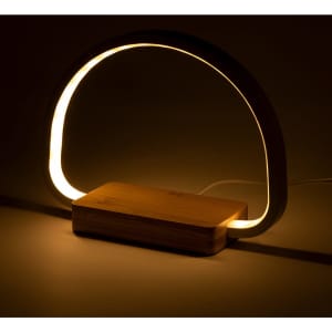 A wireless charger lamp featuring a curved light and a wooden base, designed in neutral tones.
