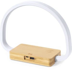 A wireless charger lamp featuring a bamboo base and a white, curved plastic arch.