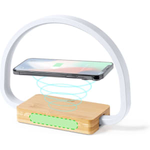 A wireless charger with a bamboo base and a white arch design, featuring a smartphone hovering above.