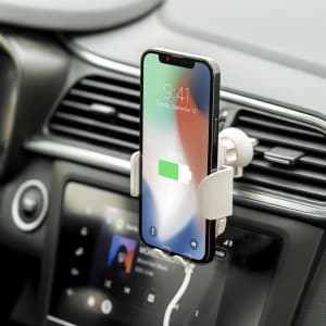 A phone holder in a car displaying a phone with a light green charging icon, featuring a sleek silver design.