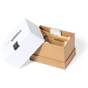 A white box partially opened, containing a wireless charger holder and packaging materials in a light brown colour.