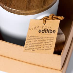 A coffee mug with a white ceramic body and a wooden lid, presented in a brown box with a tag.