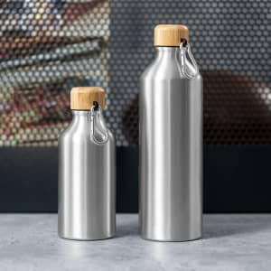 A drink bottle set featuring two stainless steel bottles with wooden tops and a metal clip, both in silver.