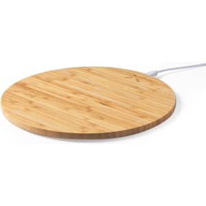 A round bamboo mousepad with a white charging cable, designed for wireless charging.