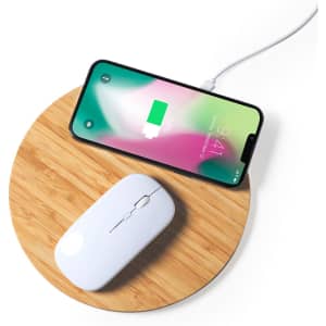 A wireless charger mousepad in a round bamboo design, featuring a white mouse and a smartphone charging.