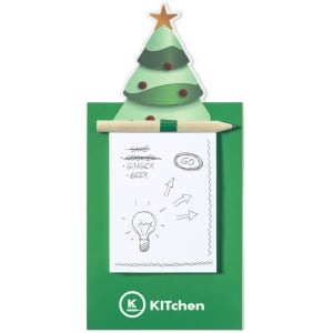 A green Christmas tree magnet with a notepad and pencil attached, featuring a festive design and a star topper.