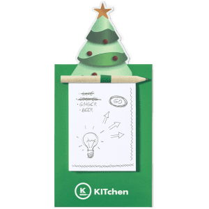 A green notepad with a Christmas tree design on top, featuring a pencil and a blank page with sketches.