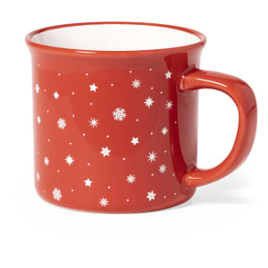 A red coffee mug with a glossy finish, featuring white star and snowflake patterns. It has a sturdy handle and a contrasting interior.