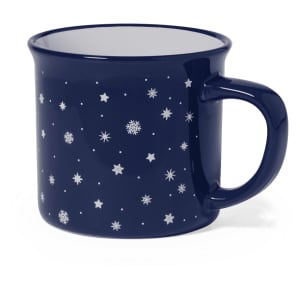 A coffee mug in navy blue featuring a design of white stars and snowflakes, with a sturdy handle and a glossy finish.