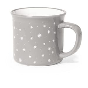 A grey coffee mug with a glossy finish, featuring white stars and snowflakes, and a sturdy handle.